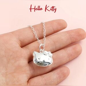 Hello Kitty™ locket necklace or adjustable bracelet, silvertone, price each